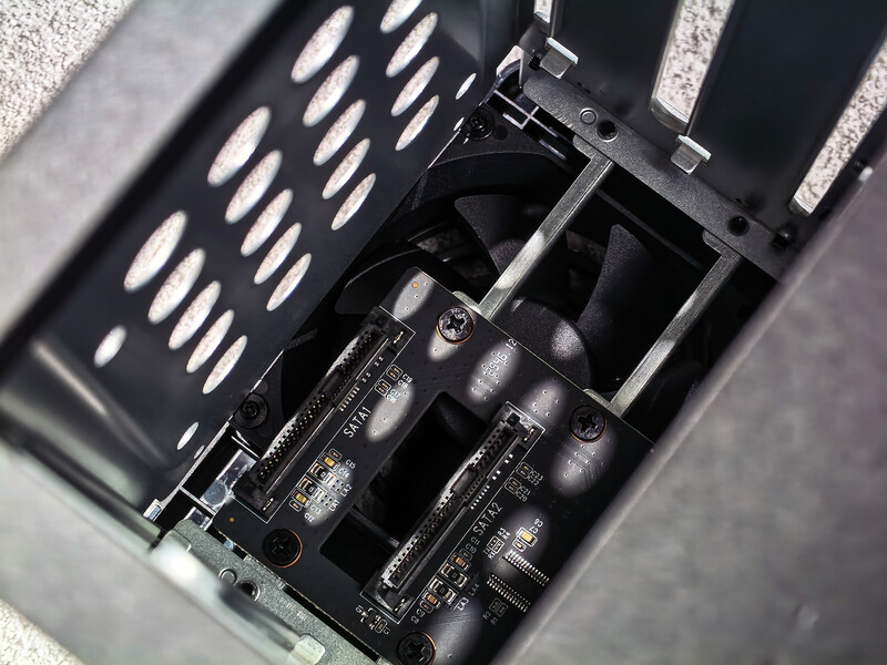 Interior view of a camera or equipment case with black foam padding and ventilation slots.