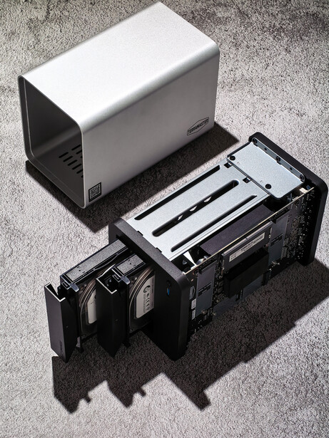 Camera film scanner with open film tray and control panel displayed on concrete surface.