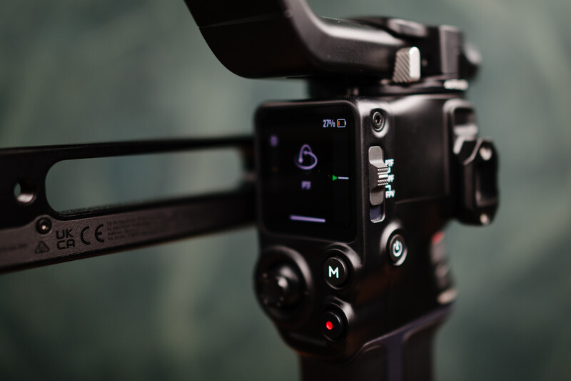 Close-up of a professional cinema camera's control panel with manual mode dial and adjustment buttons.