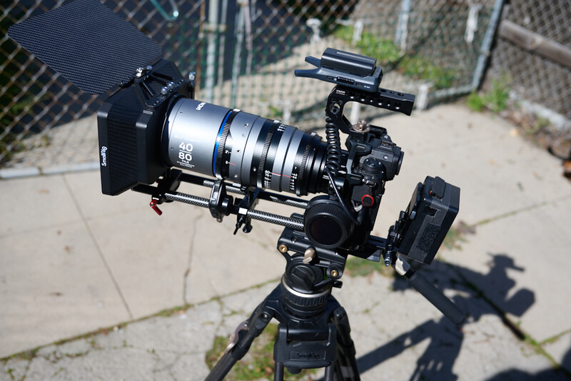 Professional cinema camera rig mounted on tripod with follow focus system and matte box attached.