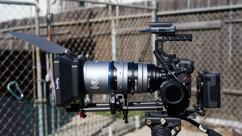 Professional cinema camera rig with follow focus system, matte box, and monitor mounted on support frame.