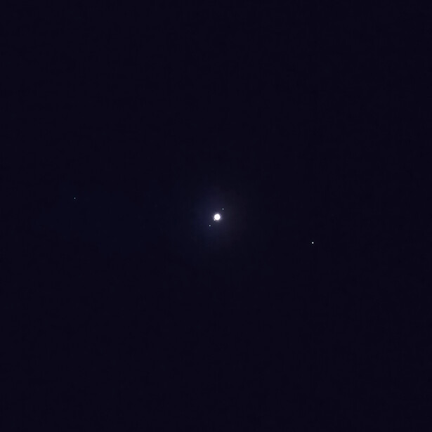 Bright star or celestial object centered against a dark night sky with minimal visible detail.
