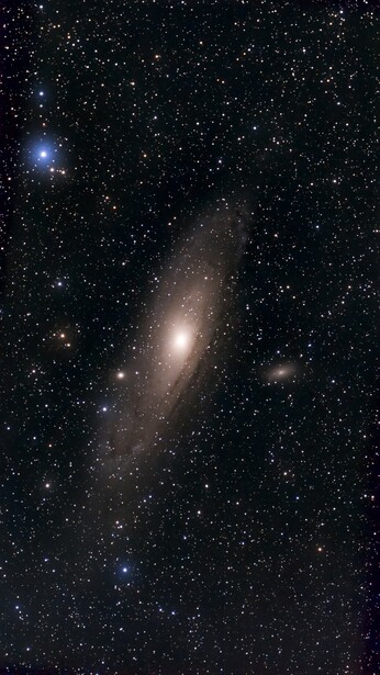 Andromeda Galaxy, a large spiral galaxy with a bright central core and dust lanes, surrounded by countless stars against a black sky.