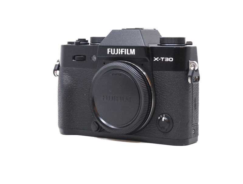 Fujifilm X-T30 mirrorless camera body shown from front three-quarter angle against white background.