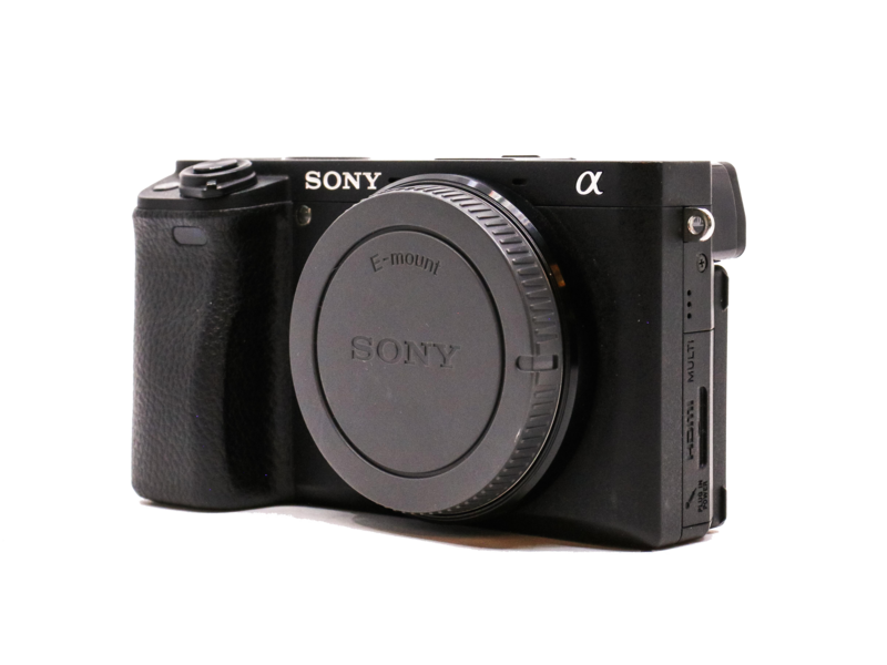 Sony Alpha mirrorless camera body with lens cap attached, shown from front three-quarter angle against white background.