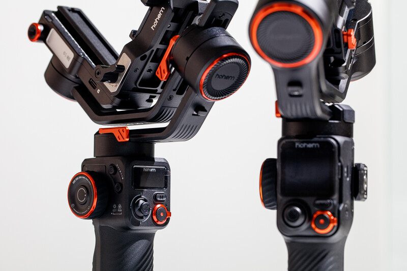 Front and back views of a black gimbal stabilizer with orange accents and control interface.