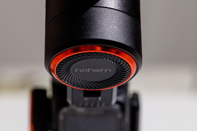Close-up of a camera gimbal's motor with red accent ring and brand text visible on dark metallic housing.