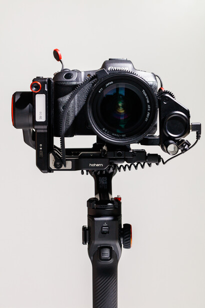 Professional camera mounted on gimbal stabilizer with wireless transmitter and follow focus system.