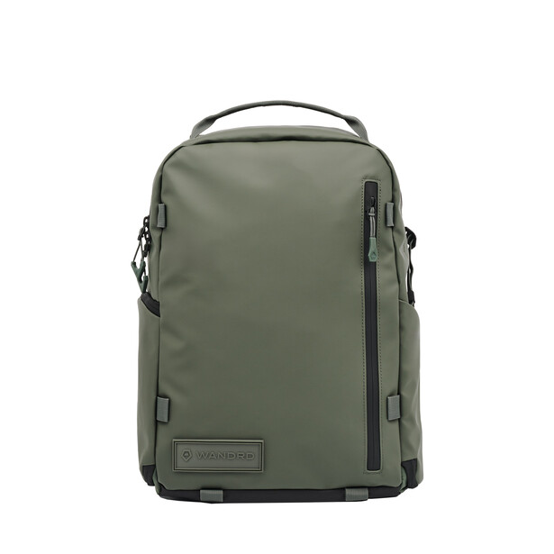 Sage green camera backpack with padded straps and front zippered pockets against white background.