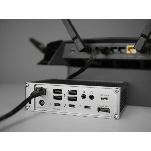 USB hub with multiple ports mounted on a wall or stand with cable management clips.
