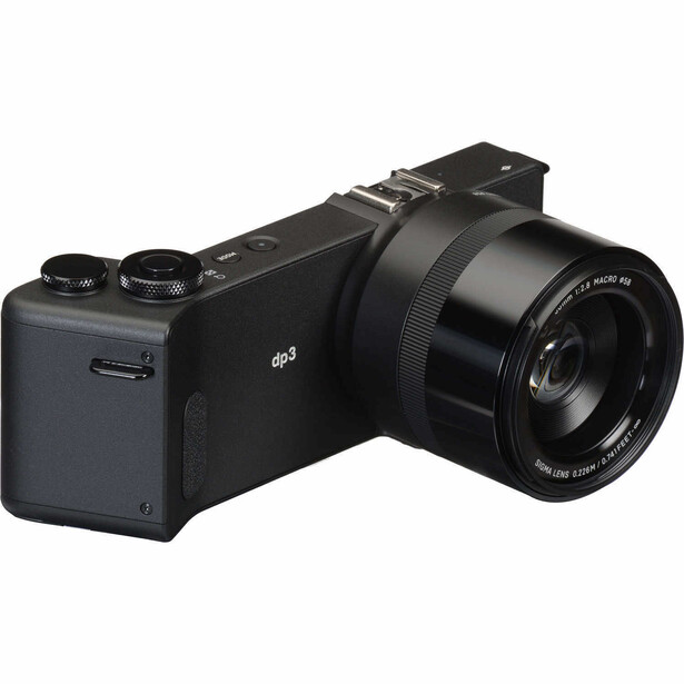Black mirrorless camera with attached lens shown from a three-quarter angle against white background.