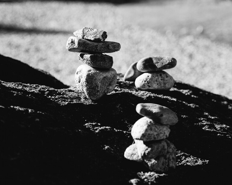Black and white photograph of small rocks stacked
