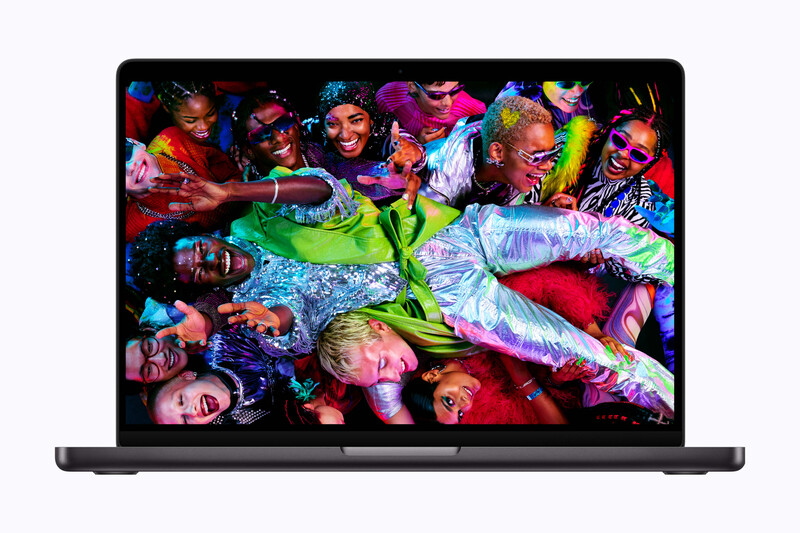 Screenshot of a laptop displaying a vibrant, colorful group portrait with multiple people arranged closely together.