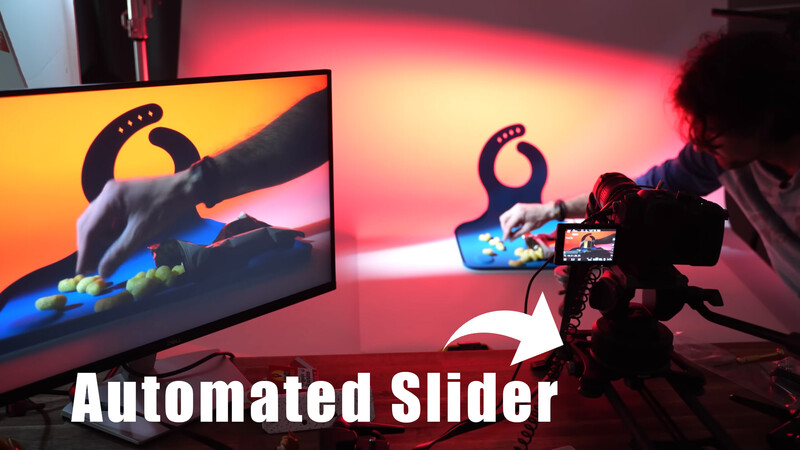 Screenshot showing an automated slider feature with a character silhouette displayed on dual monitors against warm red and orange backlighting.