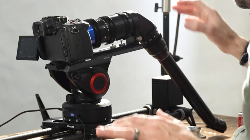 Motorized camera gimbal head with mounted cinema camera during hands-on demonstration.