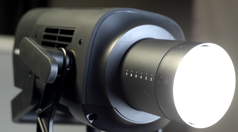 Professional LED spotlight with variable focus beam and dimmer control mounted on a stand.