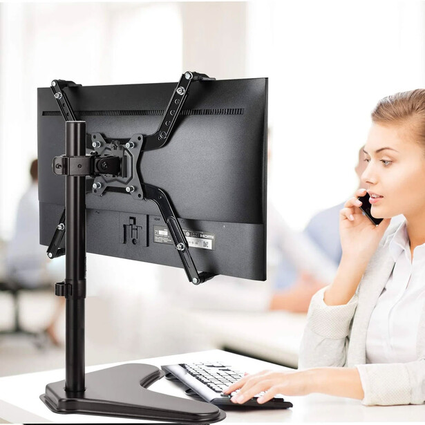 Huanuo Universal VESA Mount Adapter Kit (Model HNMUA4), holding the monitor secure