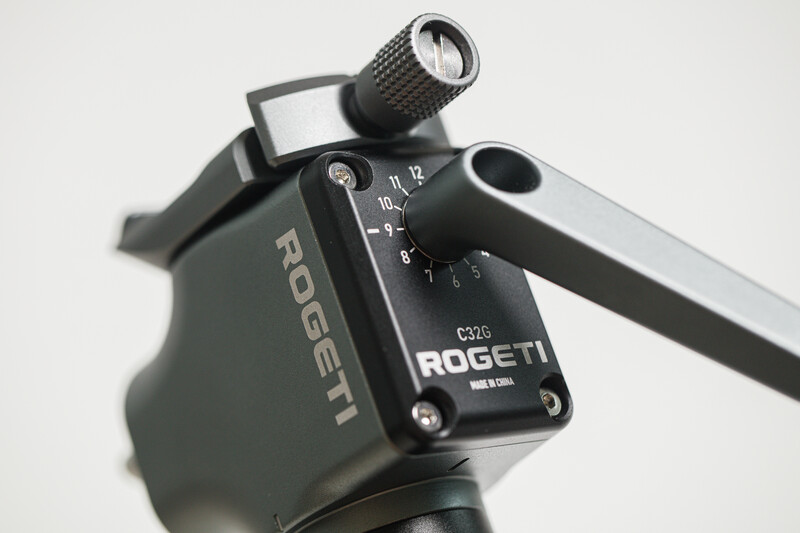 Close-up of a Rogetti fluid head mounted on a tripod with adjustment dials and controls visible.