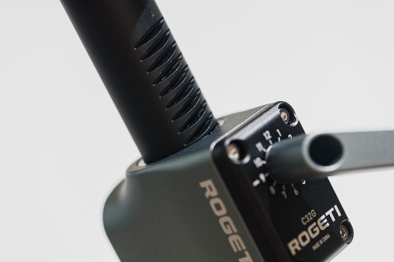 Close-up of a wireless microphone system with black foam windscreen and control module against light background.