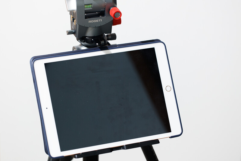Tablet mounted on tripod with surveying instrument mounted above.