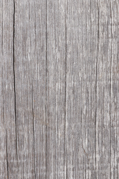 Weathered gray wooden plank surface with vertical grain texture and natural aging patterns.