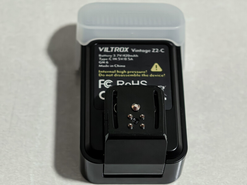 Viltrox Vultaggio Z2-C camera charger with translucent lid, shown from above against neutral background.