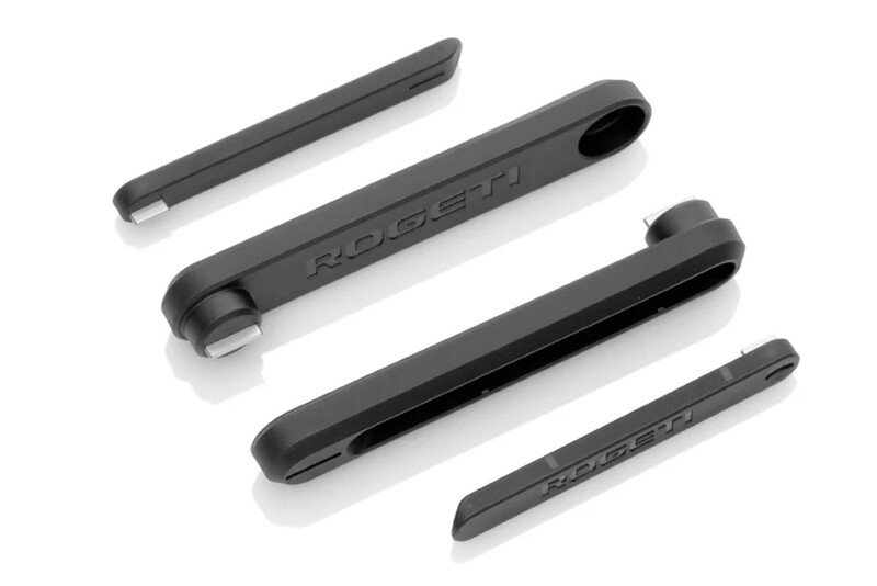 Four black plastic levers or tools arranged in descending size order against a white background.