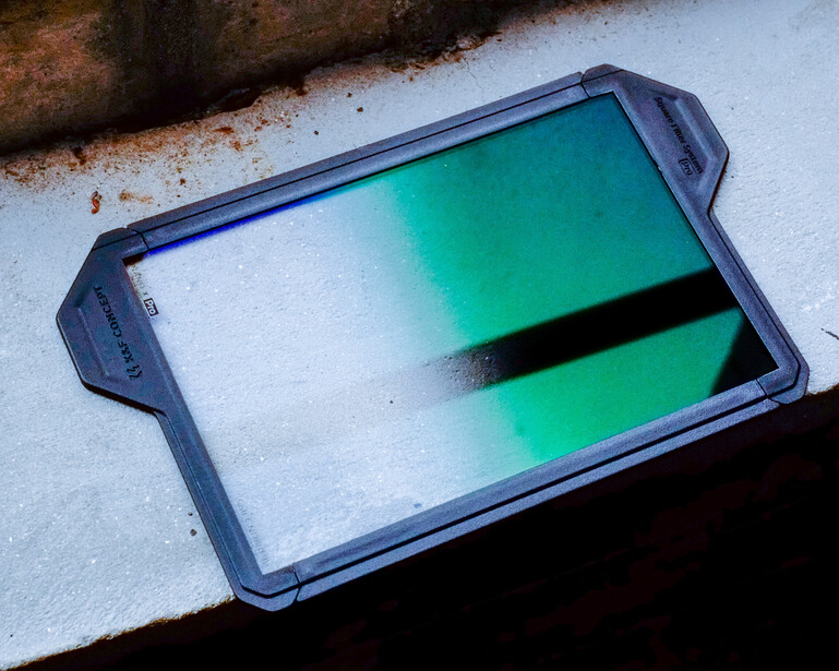 Rugged tablet device displaying a gradient test pattern with green and white color blocks.