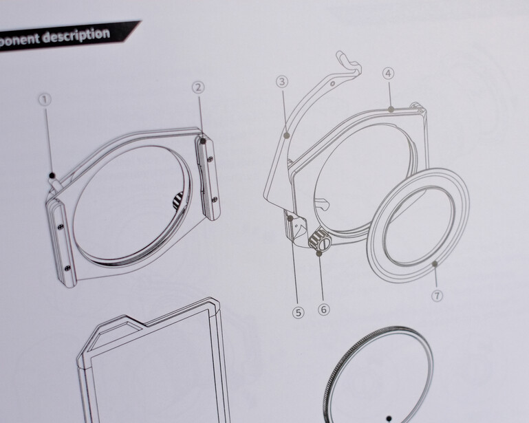 Technical illustration of camera lens component assembly showing numbered parts and their placement.
