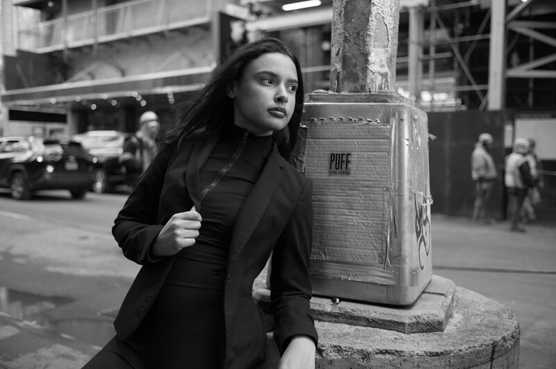 Model leaning on lampost