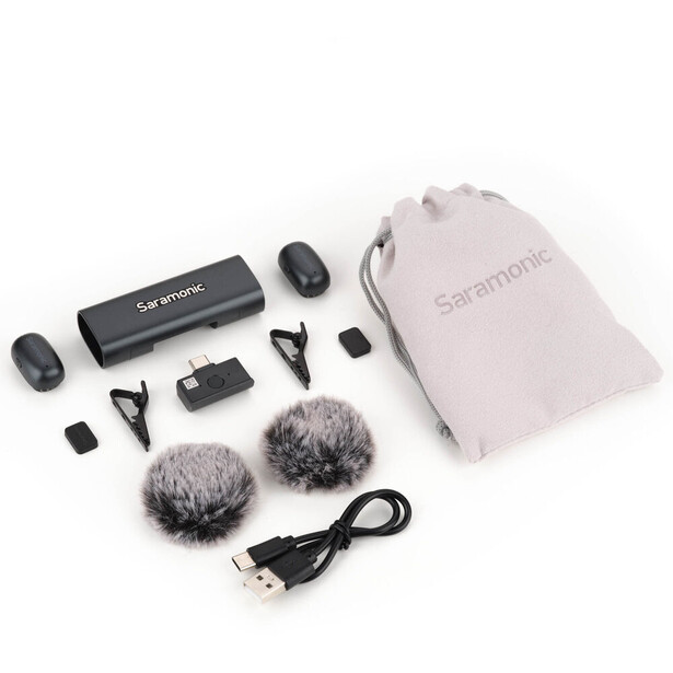 Complete wireless microphone system kit with transmitter, receiver, windscreen muffs, cables, and carrying pouch.