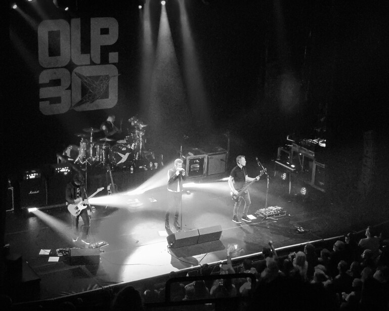 Black and white concert photo of band on stage