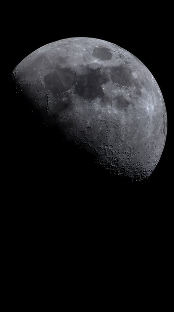 Waning gibbous moon photographed against black space, showing detailed surface craters and maria in monochrome.