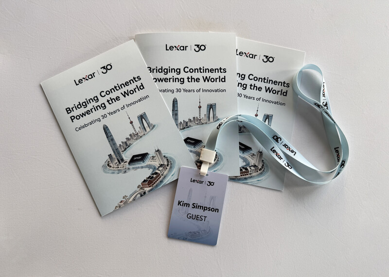 Lexar 30 promotional materials including branded books, lanyard with guest badge, and cable organizer displayed on white surface.