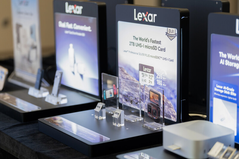 Lexar product display booth showing memory cards and promotional materials at a trade show.