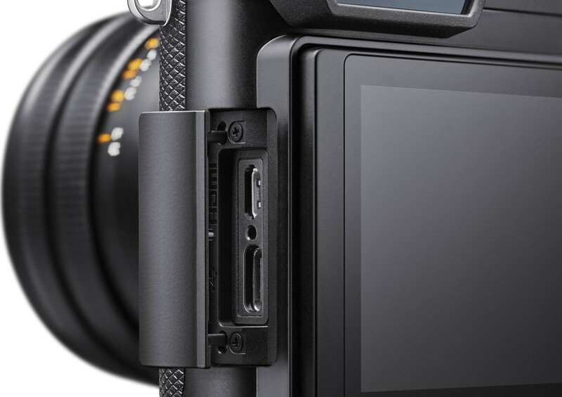 Close-up of camera body showing SD card slot and port connections on side panel.