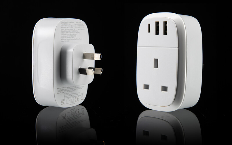 Two white travel power adapters shown from front and back angles against black background with reflections.