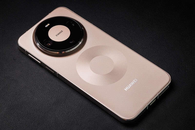 Smartphone with prominent circular camera module and magnetic ring on dark textured surface.