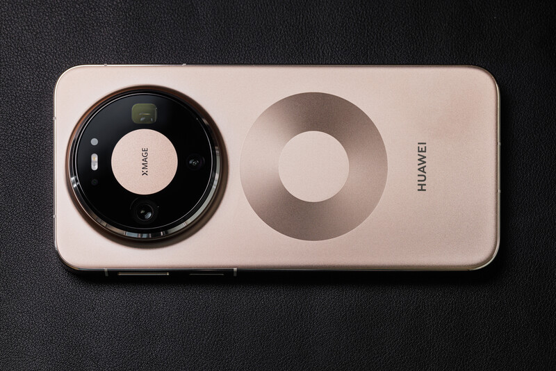 Huawei smartphone rear camera module with dual lens setup on light pink back panel.