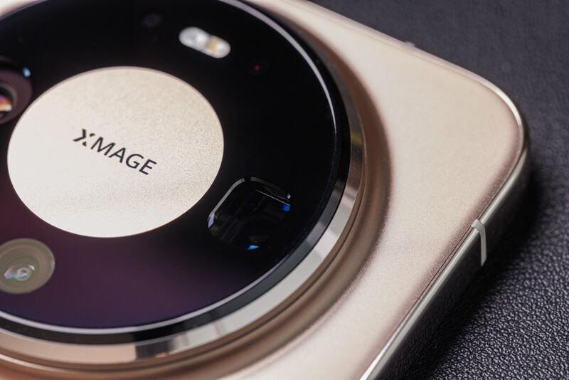 Close-up of a smartphone's camera module with a large circular lens and 2x image stabilization label visible on the back.