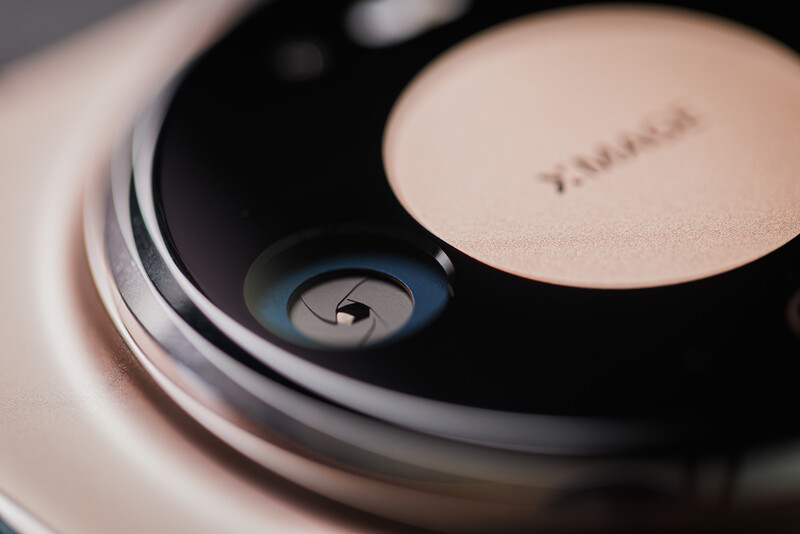 Close-up of a white wireless earbud case with charging indicator light visible on the dark interior surface.