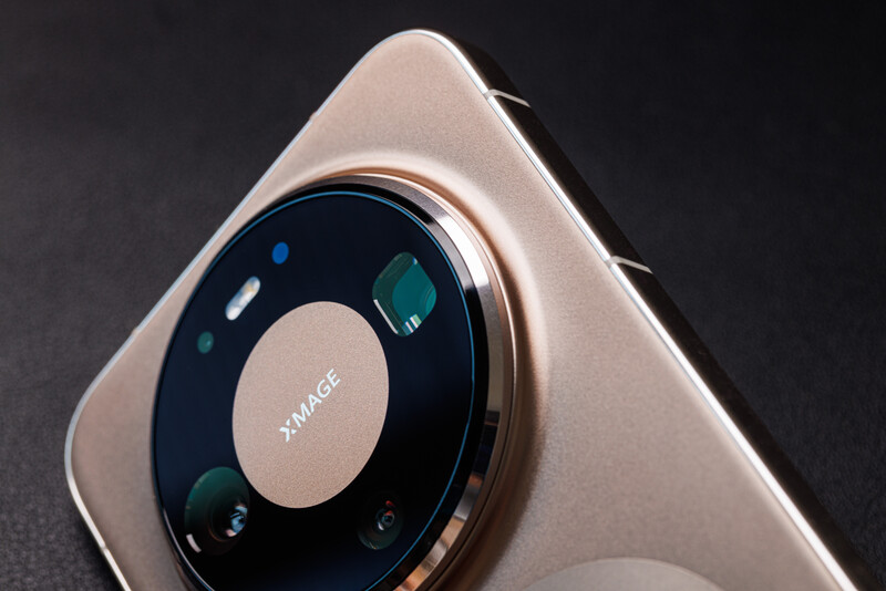 Smartphone camera module with circular lens array and multiple sensors arranged around a central dial.