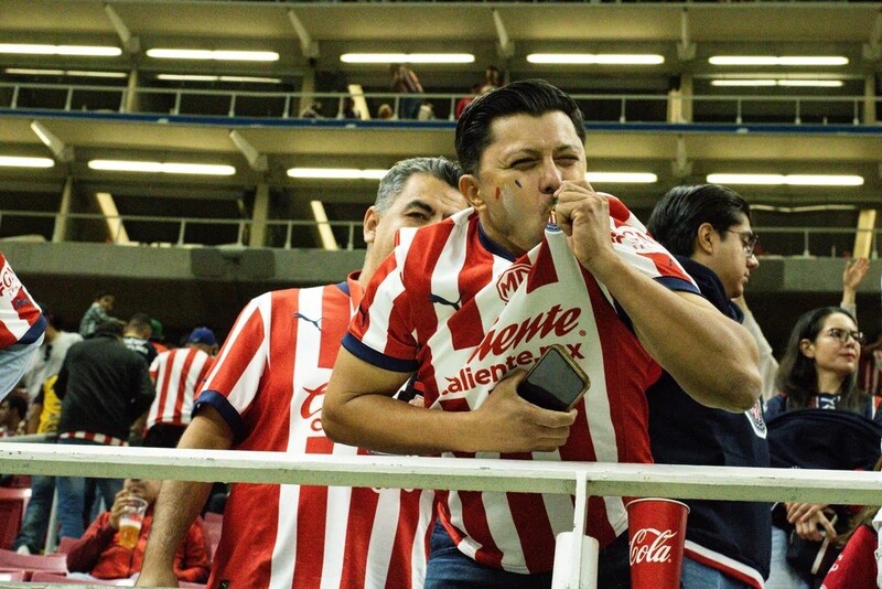 A fan during a football match kissing his t-shirt