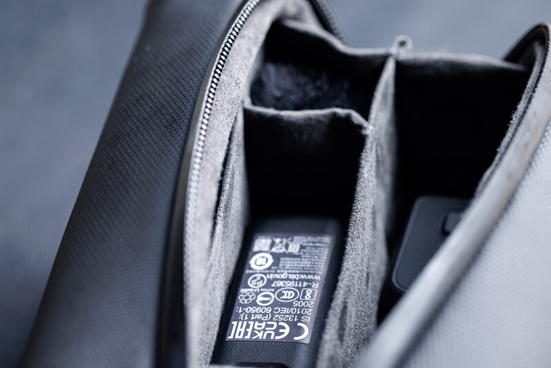Interior of a gray camera bag with multiple compartments and fabric dividers.