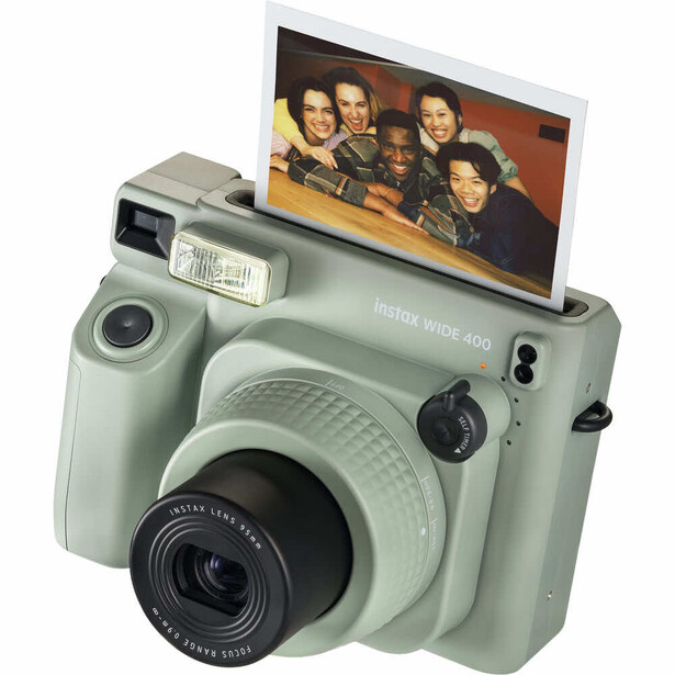 Mint green instant camera with flip-up viewfinder displaying a portrait photograph.