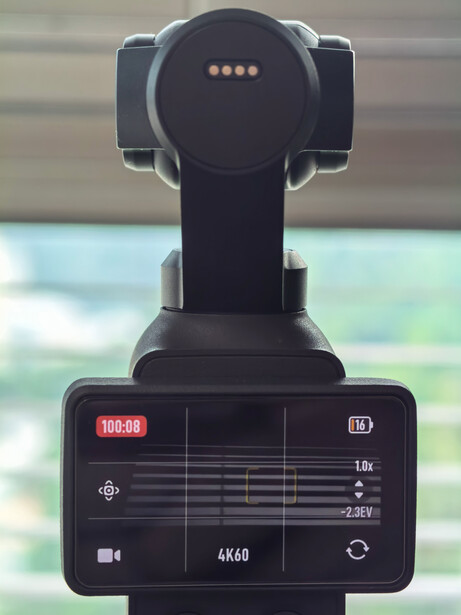 Dashboard display screen of a video camera mounted on a tripod, showing 4K60 recording settings and status indicators.