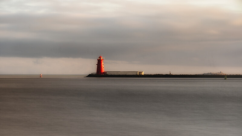 Long exposure of streaking clouds over a lone lighthouse