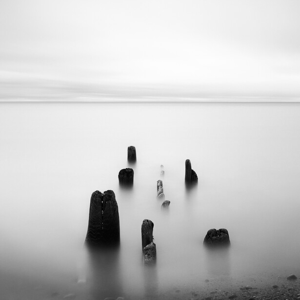 Black and white long exposure photo of posts in Lake Michigan