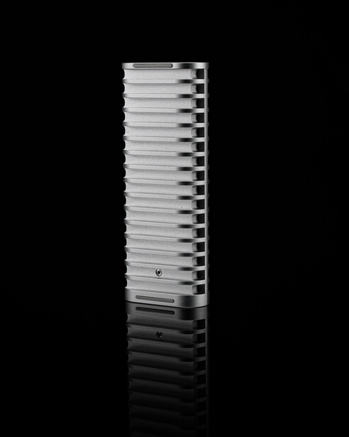 Stacked metal heatsink or thermal dissipation component photographed against black background