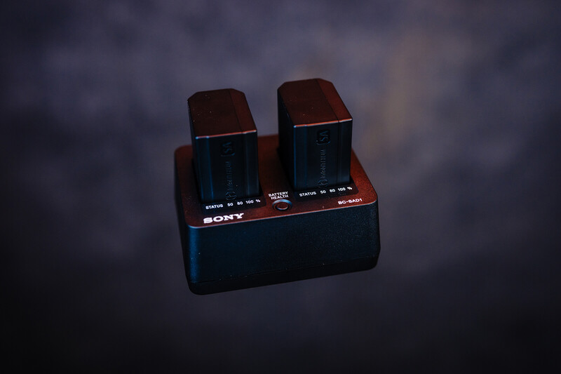 Sony wireless speaker charging dock with two speaker units in red and black